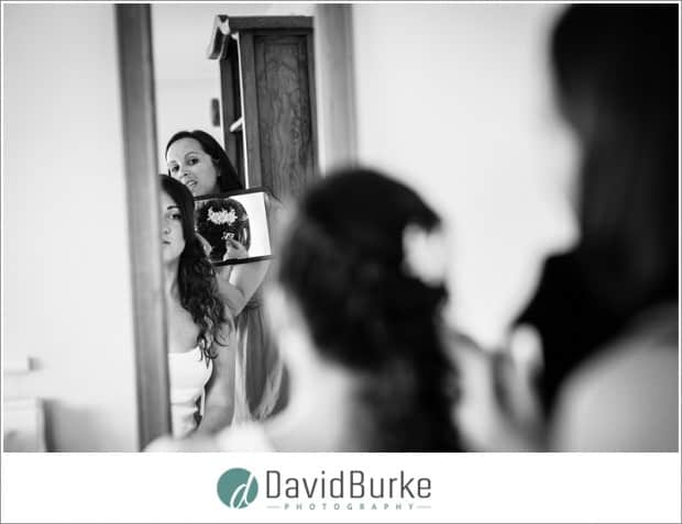 bride looking at hair in mirror