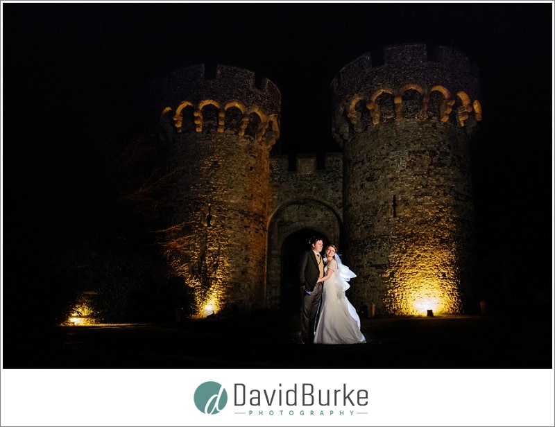 bride and groom cooling castle at night
