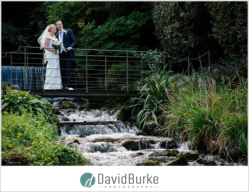 bride and groom on bridge at the orangery maidstone
