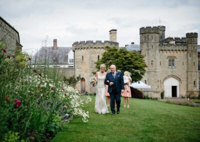bride and father on way to wedding ceremony at chiddingstone castle