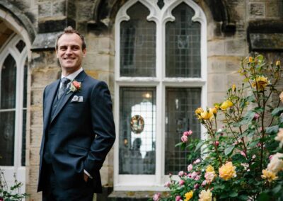 groom in rose garden chiddingstone castle